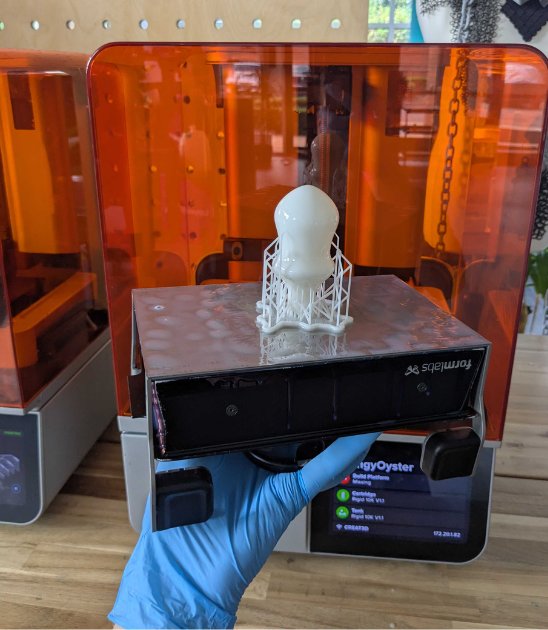 3D printed pressure bulb on build plate in front of Form 4